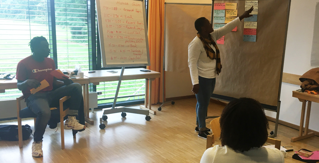 Team members in workshop session, brainstorming and posting on bulletin boards.