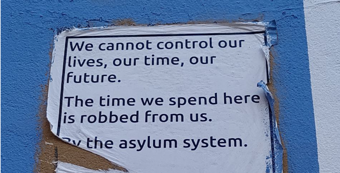 A sign posted on the outside of a building.